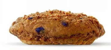 Freshly baked blueberry muffin top with golden edges and juicy blueberry bursts