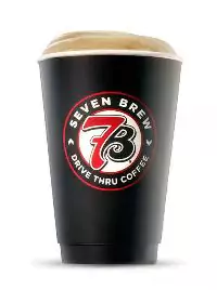 Hot cocoa topped with whipped cream and a touch of chocolate sweetness